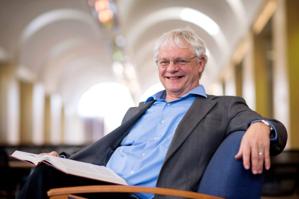 Professor Lloyd Kramer sitting with a book.
