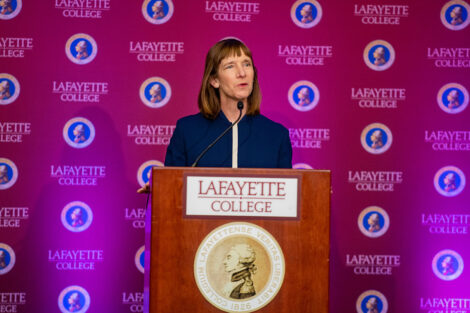 Alison Byerly speaks at podium at presidential announcement